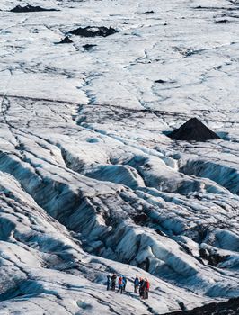 Tourist group hiking over the vast glacier