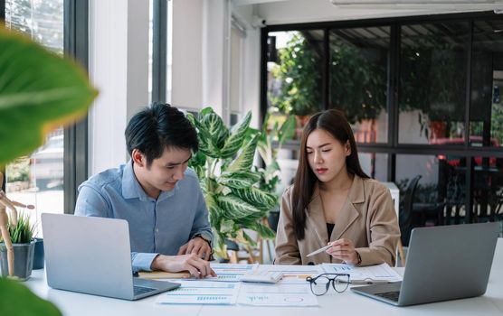 Two business asian working together with calculations for paperwork, business startup meeting discuss concept