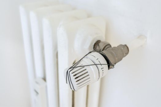 Broken thermostatic radiator valve. Waste and ecology concept.