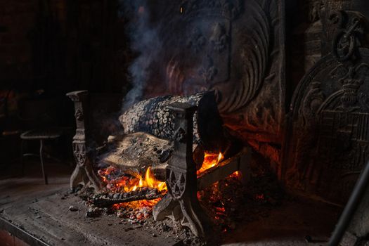 Fireplace and bonfire with firewood in an old French house