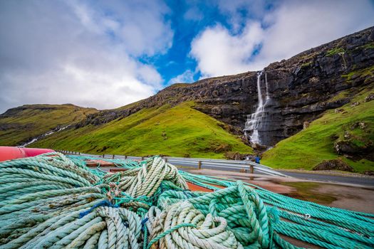 Wide angle of bunch of ends near road and waterfall