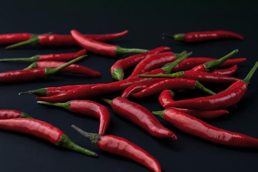 Red hot chili pepper on black background. Seasoning for real men. Fire seasoning.