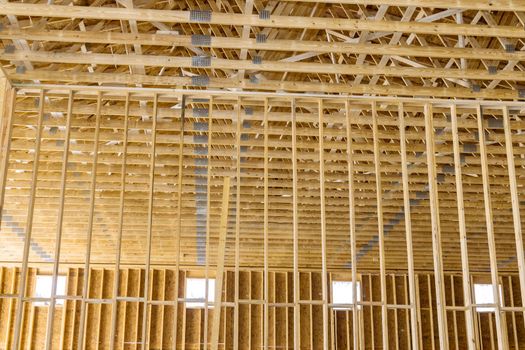 Interior view of a new house under construction framing the wood beams stick