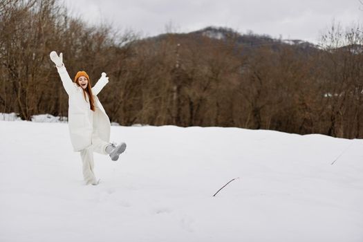 young woman in winter clothes in hats outdoors There is a lot of snow around. High quality photo