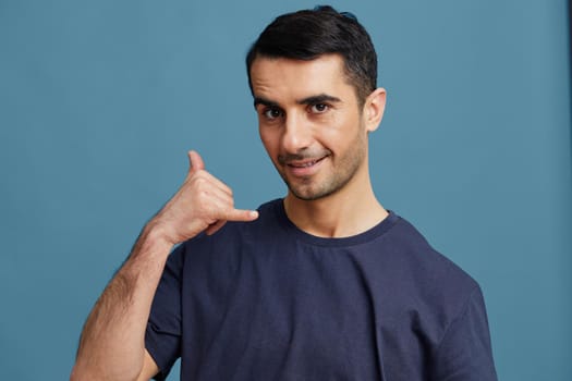 man in blue t-shirt gesturing with hand cropped view phone. High quality photo