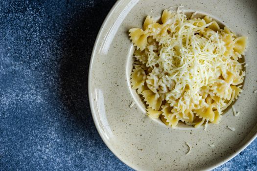 Close up of farfalle pasta with cheese served in a bowl