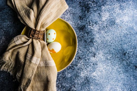 Easter minimalistic place setting on concrete background