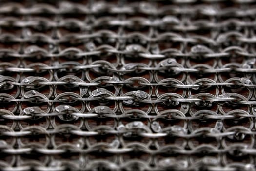 Chain-mail or Hauberk texture, metal protective armor of medieval or middle ages times. Hauberk medieval knight equipment shirt of ring mail