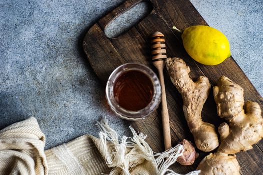 Ingredients for healthy tea with fresh lemon, ginger root and honey