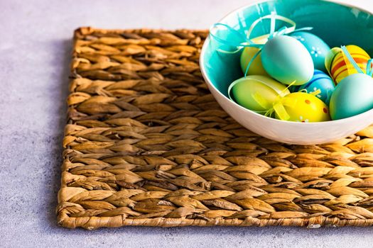 Easter frame concept with daffodils and eggs on concrete background