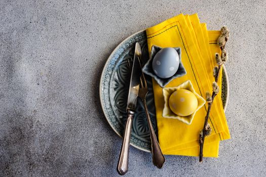 Festive table setting for holiday Easter dinner in grey color