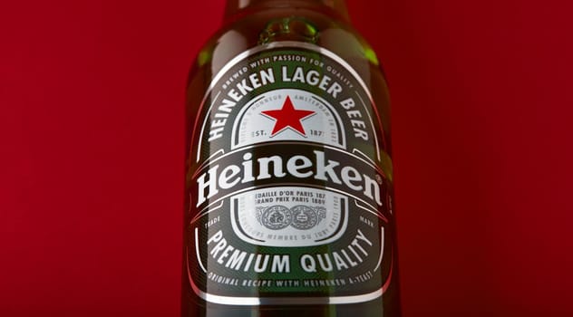 Bottle of Heineken Lager Beer on red background. Heineken is the flagship product of Heineken International. the world's most popular beer. 13.03.2020, Russia.