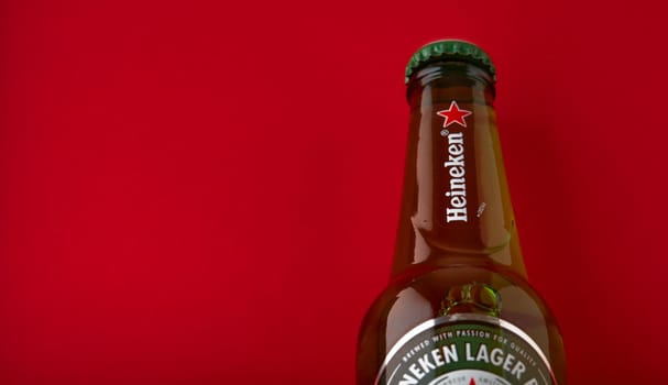 Bottle of Heineken Lager Beer on red background. Heineken is the flagship product of Heineken International. the world's most popular beer. 13.03.2020, Russia.