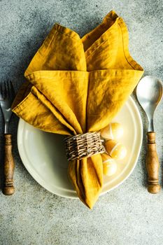Easter dinner place setting on concrete background