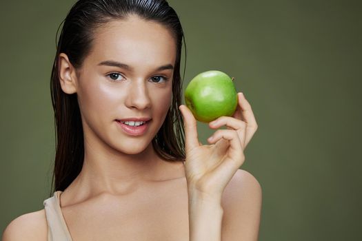 beautiful woman apple in hands posing fruit healthy food fresh Green background. High quality photo