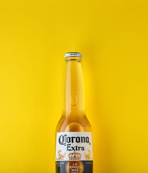 Bottle of Corona Extra Beer. On yellow background. Corona is made in Mexico and is the top selling imported beer in the United States. 13.03.2020, Russia.