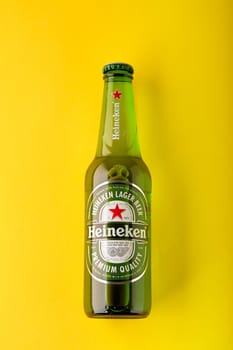 Bottle of Heineken Lager Beer on yellow background. Heineken is the flagship product of Heineken International. the world's most popular beer. 13.03.2020, Russia.