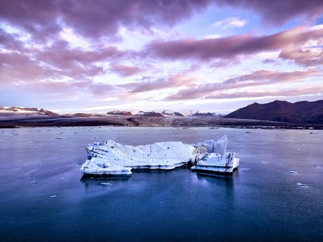 Aerial view of Glacier lagoon in Iceland during the sunrise. Ice floes calved from the glacier. melting ice