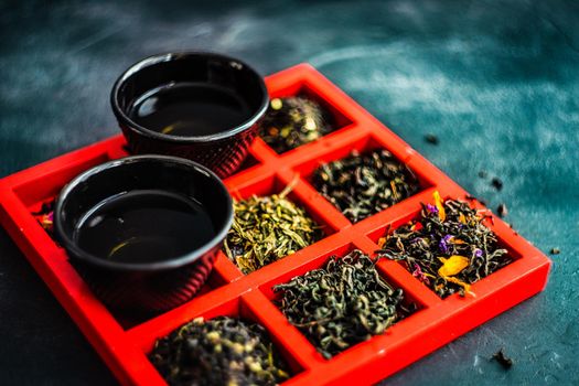 Tasty spring green tea in cups on stone table