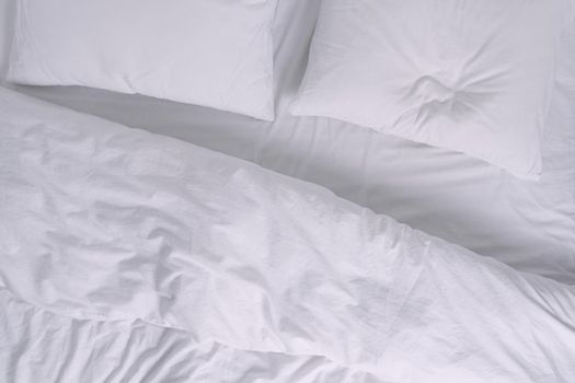 Top view of white bed with pillows. High quality photo