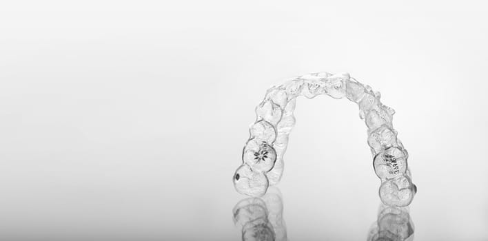 Invisible orthodontics cosmetic brackets, tooth aligners, plastic braces. Modern teeth retainers created on a 3d printer. A way to have a beautiful smile and white teeth.