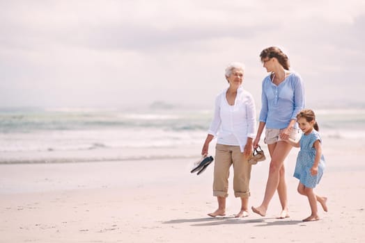 Portrait of a woman with her daughter and mother at the beach.