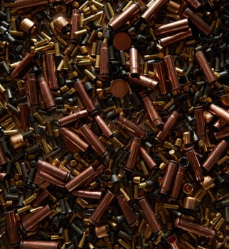 Different size bullet shells on the black ground. War concept. production of ammunition at the factory. brass bullet shell, ammunition manufacturing process