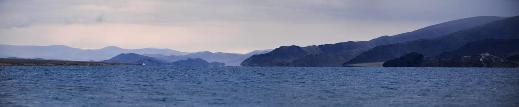 Panorama of a mountain lake. Somewhere in the vastness of Mongolia.