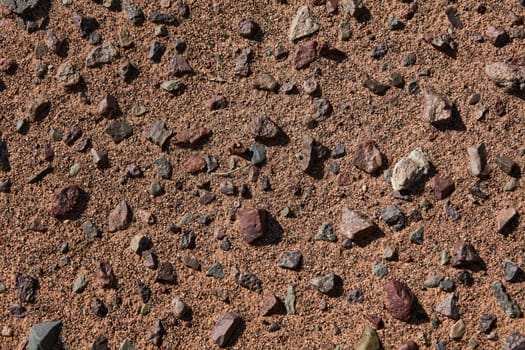 Black Gobi. Stony desert, black stones on the sand. Abstract natural background.