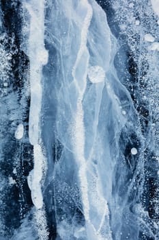 Texture of ice of Baikal lake in Siberia. blue lake ice.