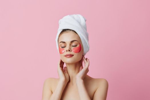 woman pink patches on the face with a towel on the head close-up Lifestyle. High quality photo