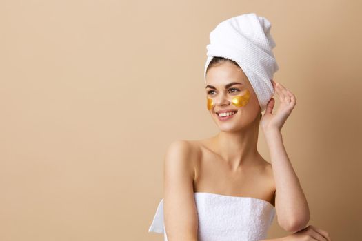young woman with a towel on his head gesturing with his hands skin care close-up Lifestyle. High quality photo