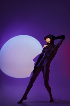 Beautiful fashionable girl posing on stage spotlight silhouette disco studio model unaltered. High quality photo