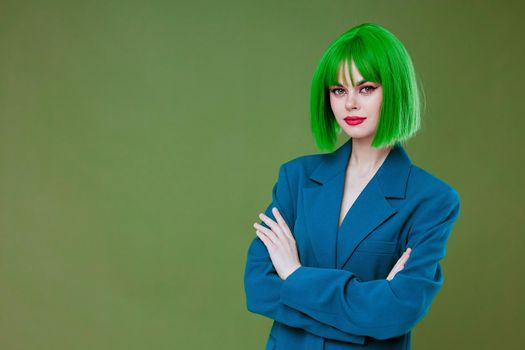 Pretty young female Glamor green wig red lips blue jacket green background unaltered. High quality photo