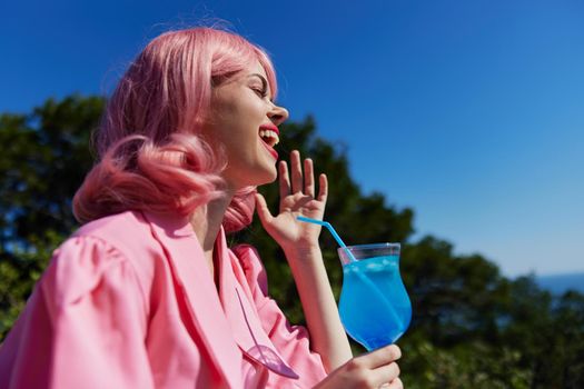 cheerful woman drinking a cocktail on the terrace Happy female relaxing. High quality photo