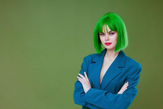 Beautiful fashionable girl attractive look green wig blue jacket posing color background unaltered. High quality photo