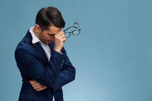 handsome businessman with glasses blue suit hand gestures emotions isolated background. High quality photo