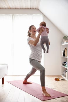 Shot of an attractive young woman bonding with her baby girl while doing yoga.