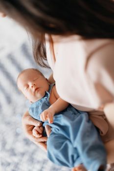 newborn falling asleep in the arms of his mother. a photo with a place for the text.