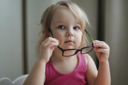 portrait of a little funny girl in eyeglasses 
