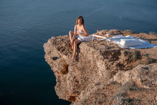 Woman wake up in bed wuth duvet and pillow over nature sea background outdoors. Back view. Good morning. Freedom concept