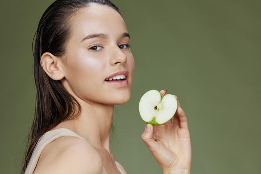 woman apple in hands posing fruit healthy food fresh Green background. High quality photo