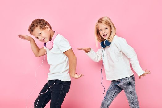 boy and girl stand next to in headphones studio childhood. High quality photo
