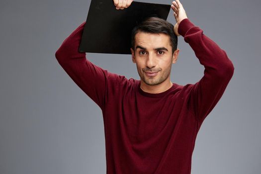 a man with a folder for papers holds it over his head documents office. High quality photo