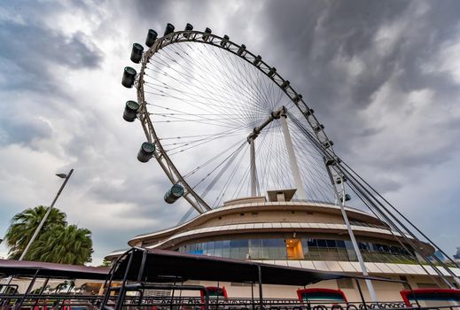 The huge ferris wheel in Singapore, a local landmark, a view from below in cloudy weather. High quality photo