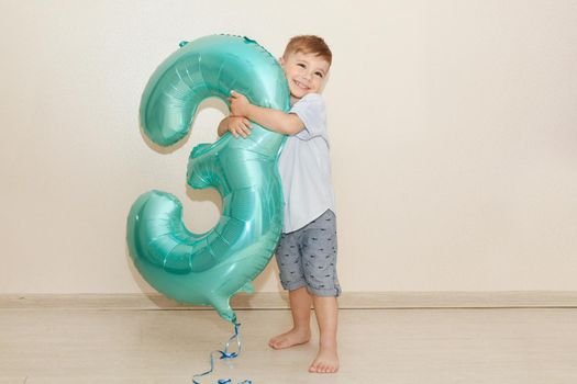 Boy holding number three for his birthday