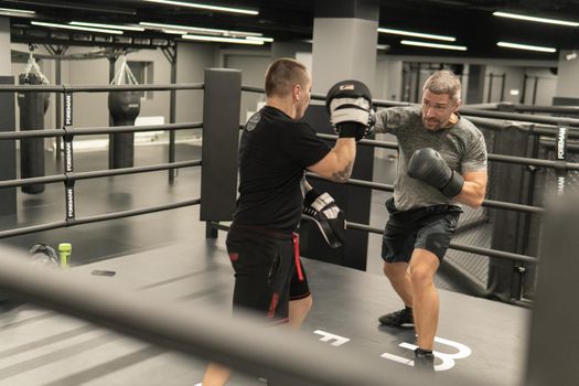 RUSSIA, MOSCOW - FEB 14, 2022: boxing training gym woman bag, from strength sport for exercise for punch body, macho angry. Energy guy challenge, workout hit