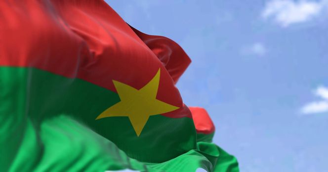 Detail of the national flag of Burkina Faso waving in the wind on a clear day. Democracy and politics. Patriotism. Selective focus. Burkina Faso is a landlocked country in West Africa