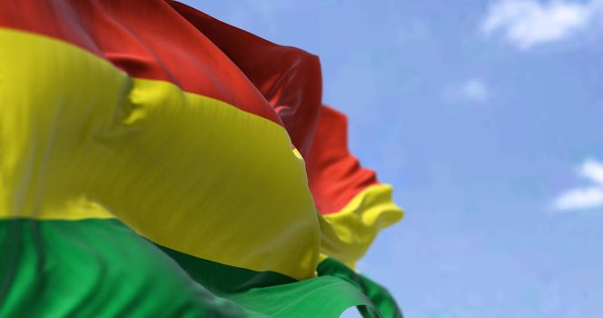 Detail of the national flag of Bolivia waving in the wind on a clear day. Bolivia is a landlocked country located in western-central South America. Patriotism. Selective focus.