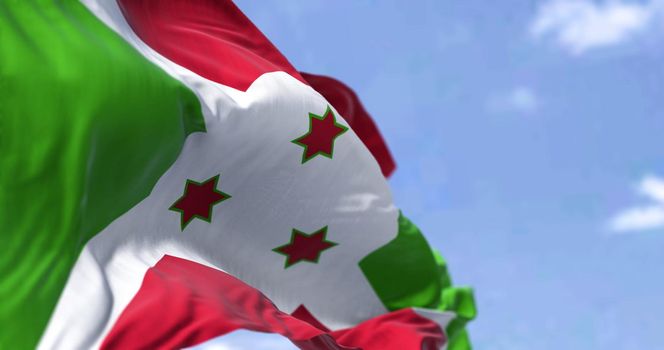Detail of the national flag of Burundi waving in the wind on a clear day. Democracy and politics. Patriotism. Selective focus. Burundi is a landlocked country in East Africa